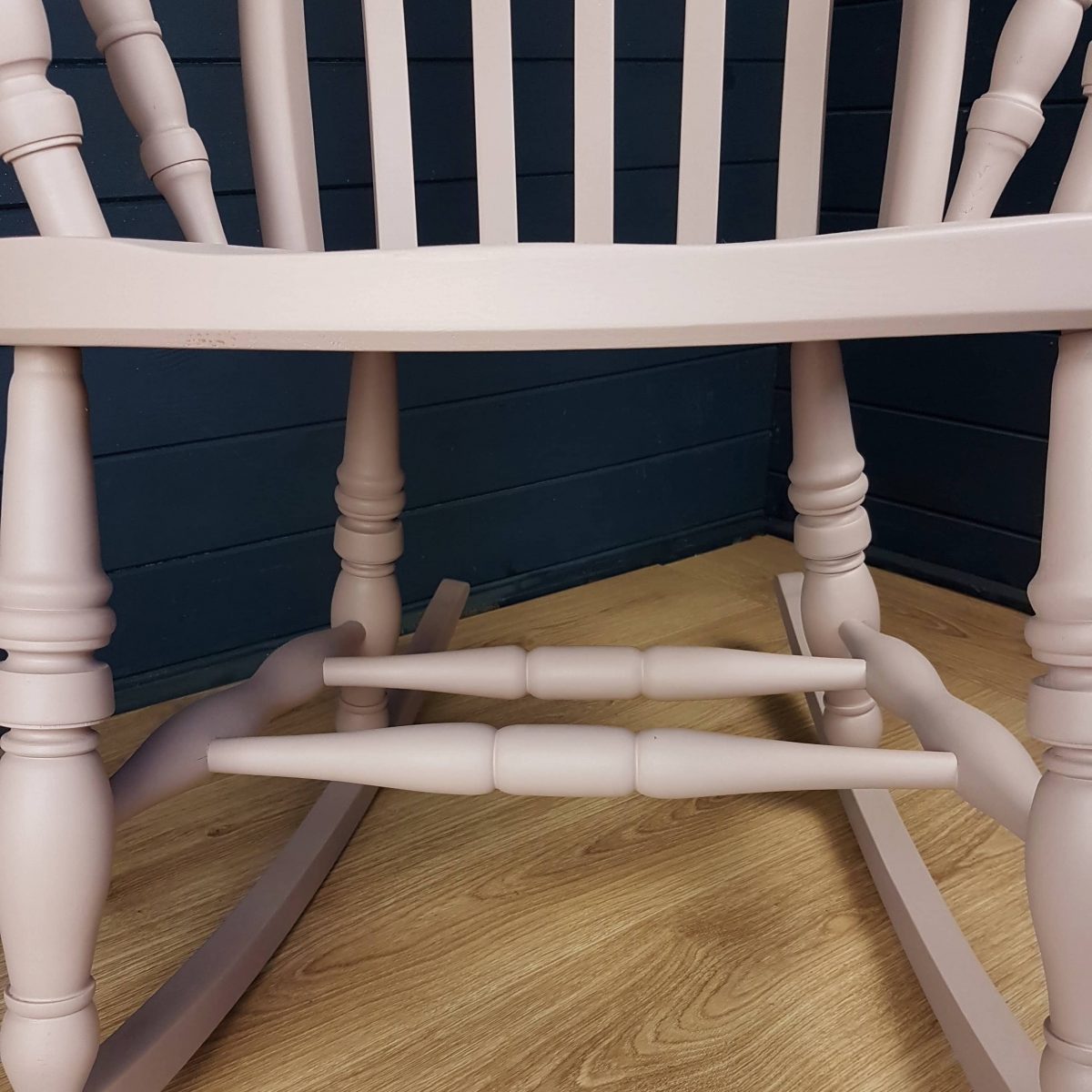 Two-tone pink and white painted wooden rocking chair
