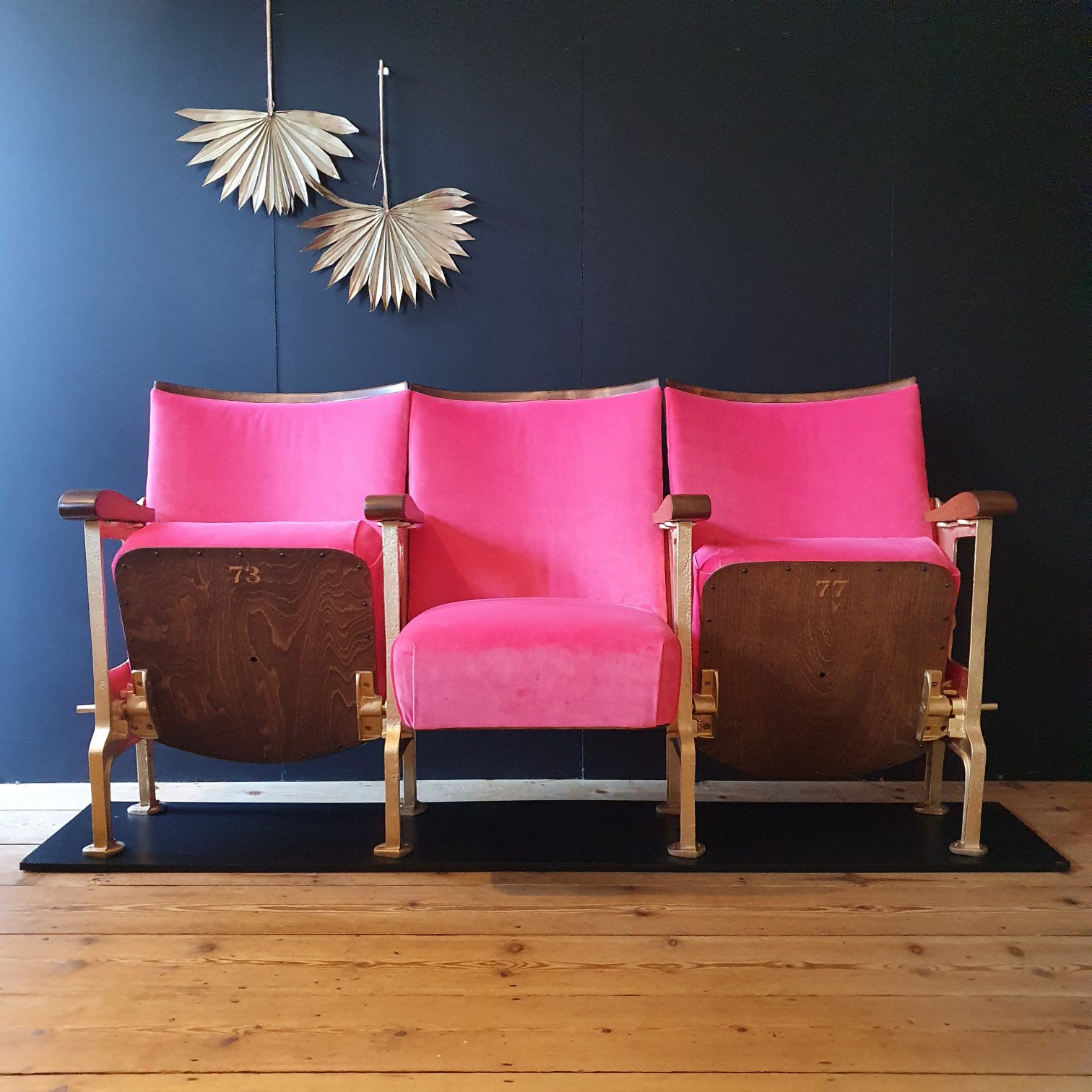 Three vintage cinema seats in a pink velvet