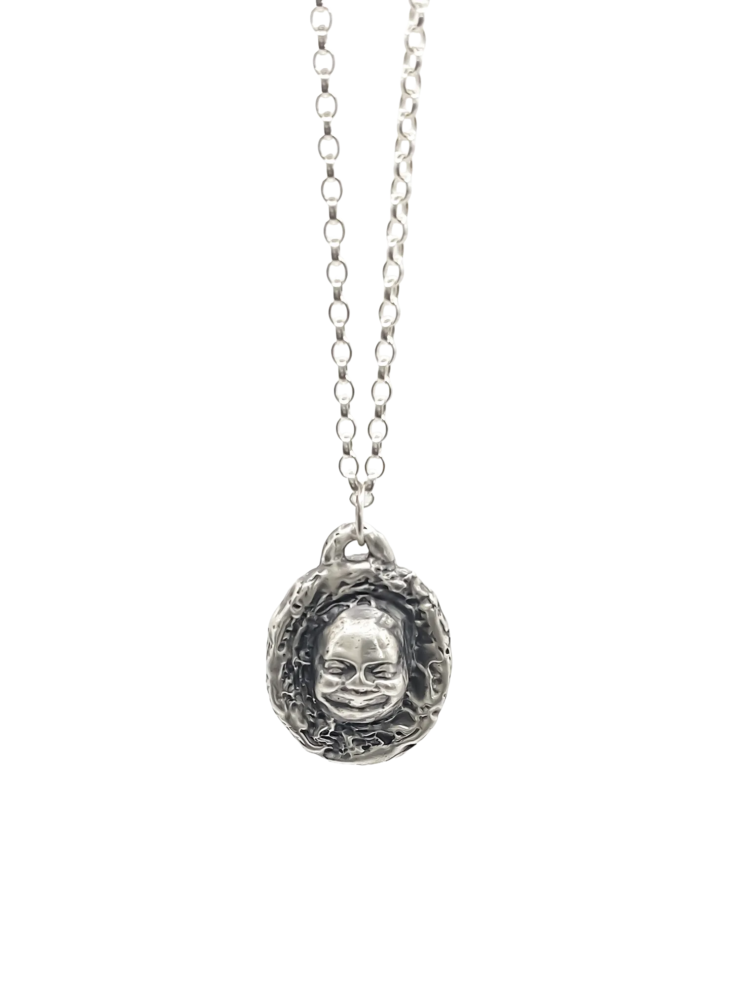 Buddha Face Pendant hanging on chain, full view against white background
