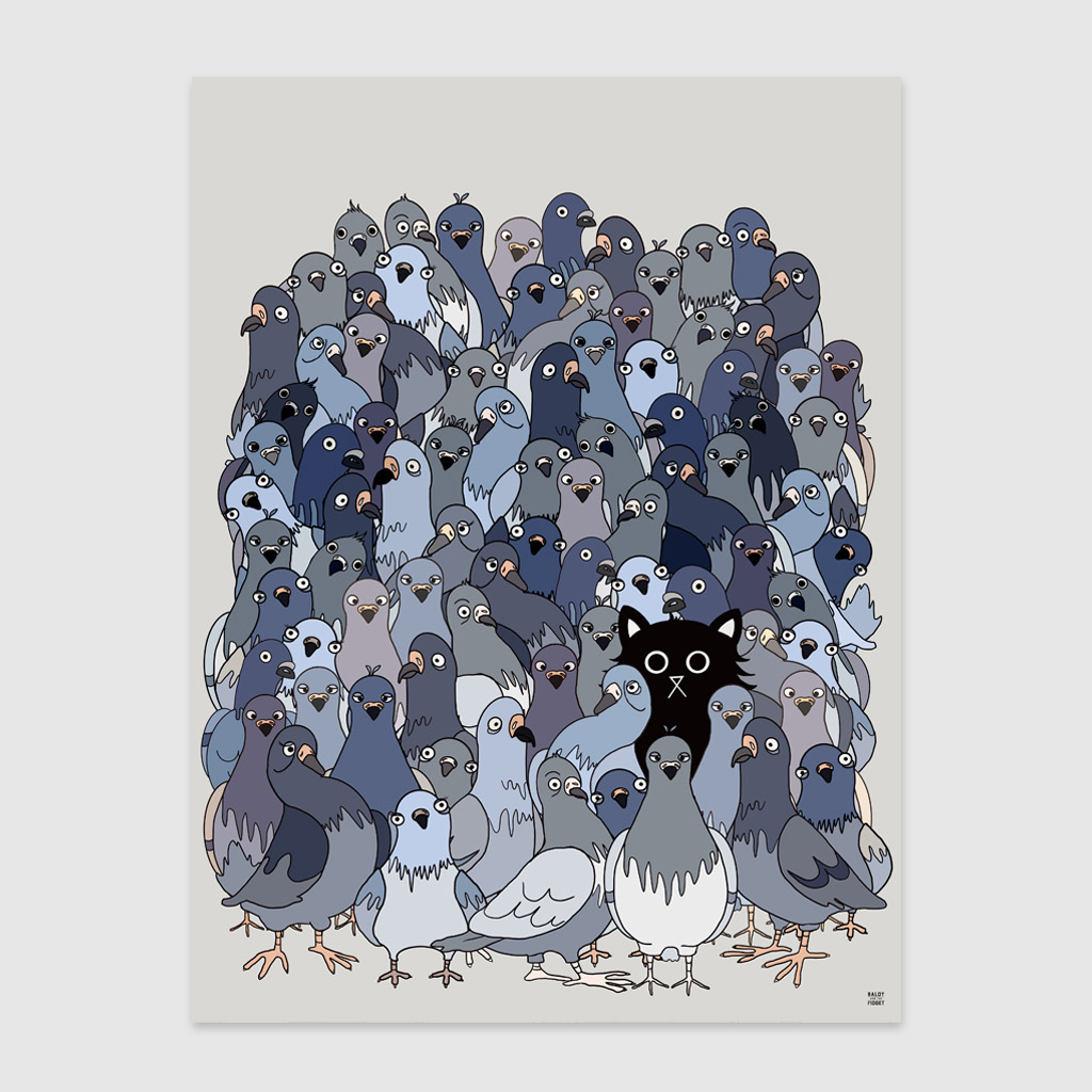 Framed illustrated art print of a large flock of grey and blue pigeons with a single black cat hidden among them, displayed in a light wood frame on a pale wooden sideboard with neutral home décor accessories.