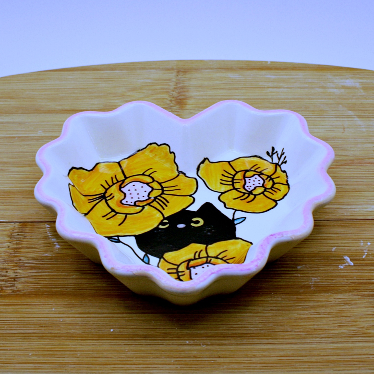 Heart shaped tray white with a floral motif and a black cat