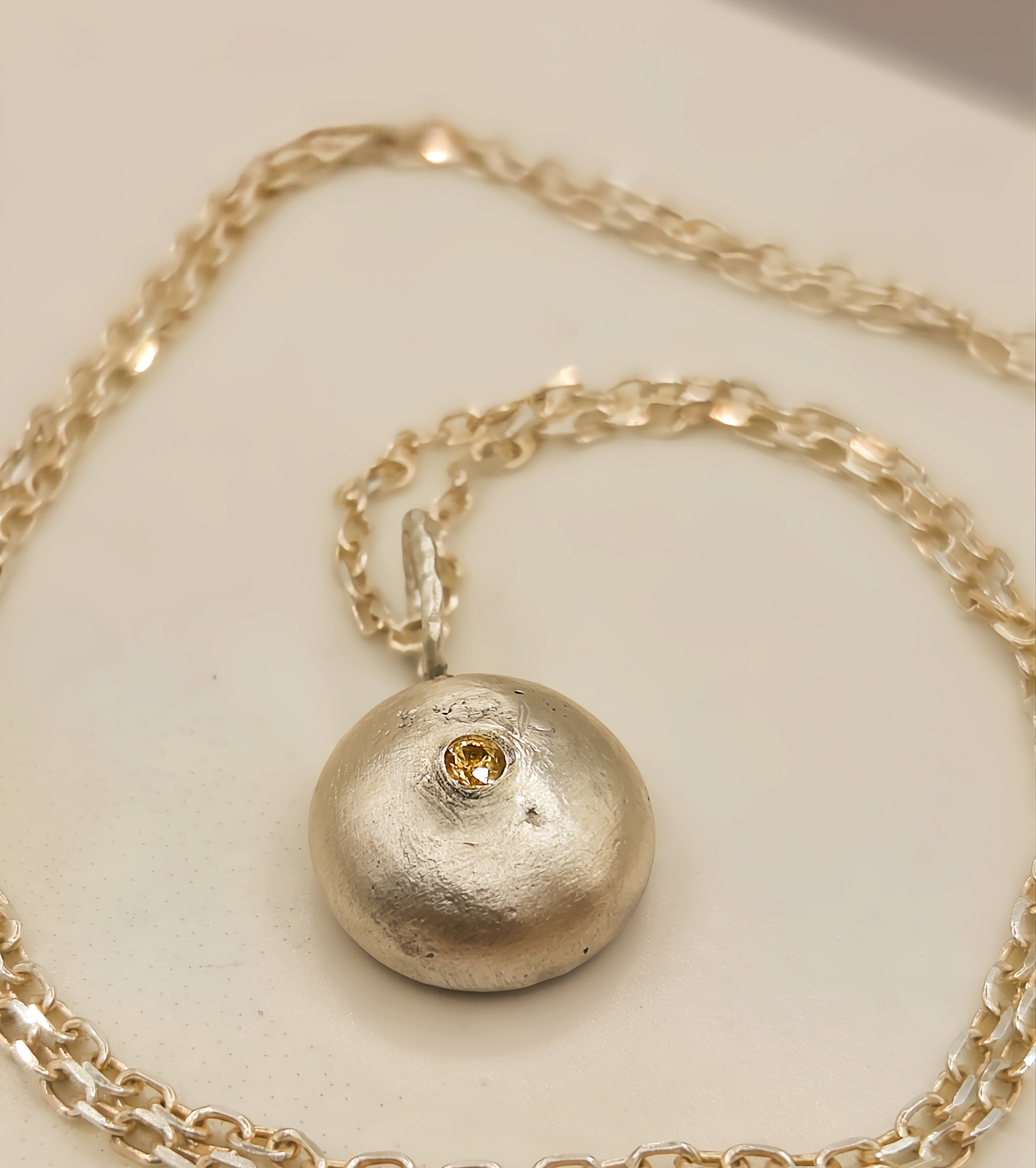 Molten Silver Pebble Pendant with Yellow Sapphire